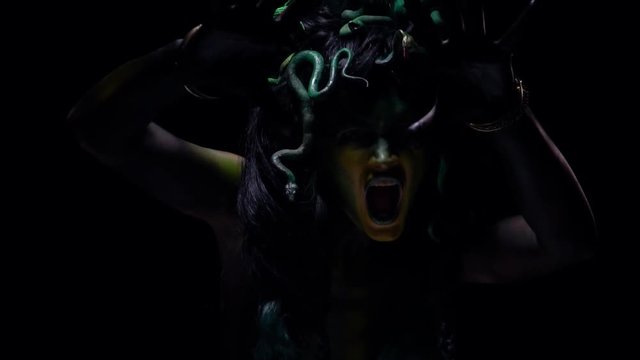 Irritated Medusa Gorgona, screming and reaching her claws