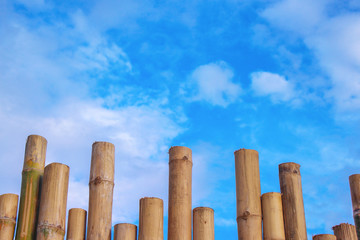Bamboo fence patterns and vivid blue sky with clouds background