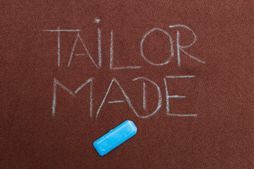 Tailor made text with blue tailoring chalk.