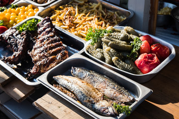 Outdoor Cuisine Culinary Buffet with healthy take away meal - grilled vegetables, fish and meat on the street food culinary market, festival, event.