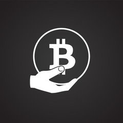 Bitcoin in hand on black background icon