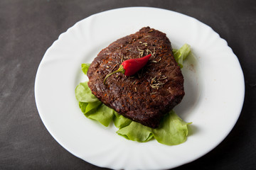 beef steak on black background, top view