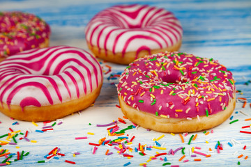 Donuts on a blue wooden background.