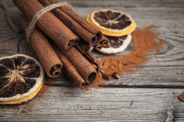 Cinnamon sticks on wooden background.