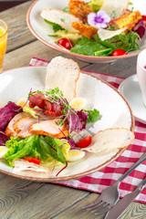 Fresh salad with chicken breast, arugula and tomato. Top view