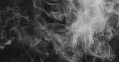 closeup vapor rises from bottom on black background