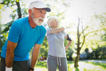 Mature couple jogging and running outdoors in city