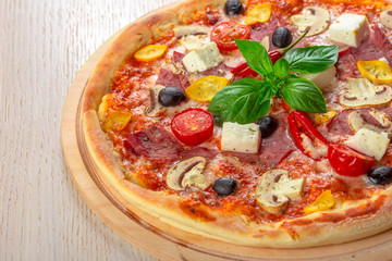 Pizza with Mozzarella, Ham, Cherry Tomatoes, Black Olives