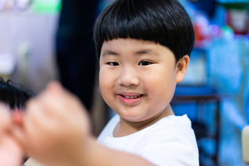 A boy is holding his parent finger to show his trust and believe.