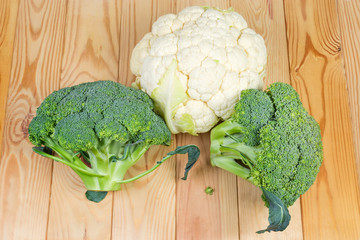 Heads of broccoli and cauliflower on the wooden rustic table