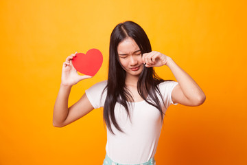 Asian woman sad and cry with red heart.