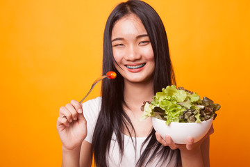 Healthy Asian woman with salad.