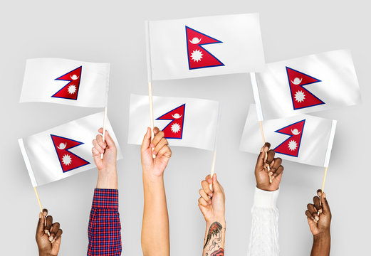 Hands waving flags of Nepal