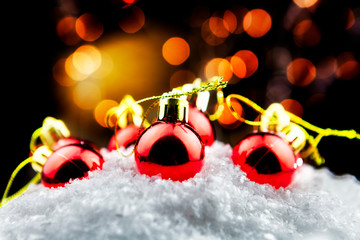 Christmas balls in the snow with bokeh