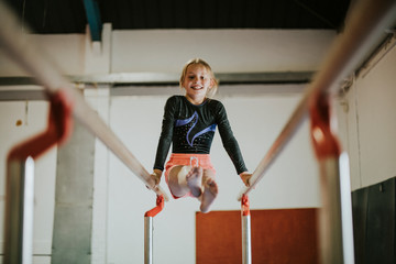 Young gymnast on parallel bars