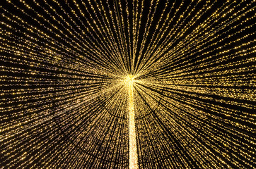 Christmas street light strings at night yellow colored. Holiday lights tent.