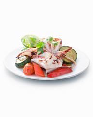 Grilled calamari with vegetables on white plated, close-up