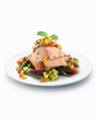 Salmon with vegetables on white plated, close-up