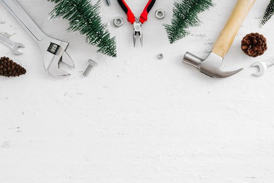 Merry Christmas and Happy new year handy tools and Christmas ornaments decoration on grunge white wood background concept. Top view with copy space.