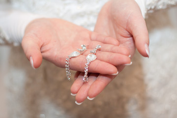 earrings in hands