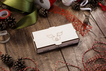 Closed plywood box with drawn pig (symbol of coming year) on the cover lies  on a wooden table...
