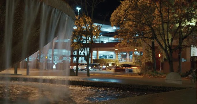 Busy City Action at Night Time Lapse Loop by Park Fountain Water