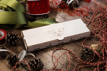 Closed plywood box with drawn pig (symbol of coming year) on the cover lies  on a wooden table...