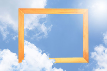Square wooden frame, Creative Beautiful blue sky with white clouds for background . with paper card note. Blank for advertising card or invitation. Nature concept.