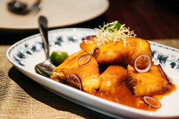 Fried red snapper fish orange sauce Singaporean cuisine