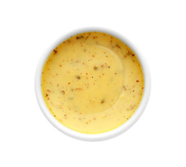Tasty yellow sauce in bowl on white background