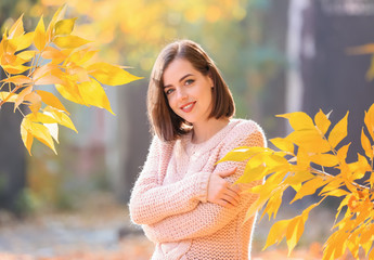 Beautiful young woman in autumn park