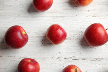 Ripe tasty apples on wooden table