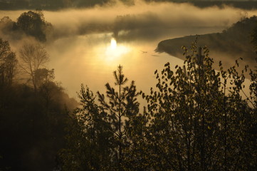 Sunrise. The river in the mist. A view of the meadows and the river in the morning.