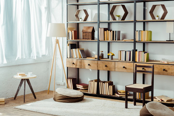 interior of living room with wooden furniture and books - obrazy, fototapety, plakaty