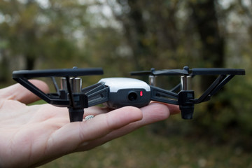 Drone with low battery red light blinking, held on hand
