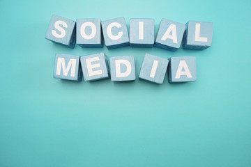 Social Media created with cubes alphabet letters on blue background