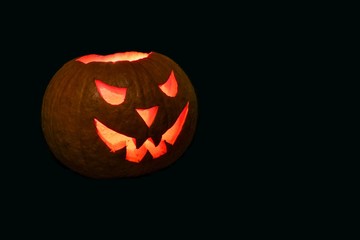 halloween pumpkin with red eyes on black background