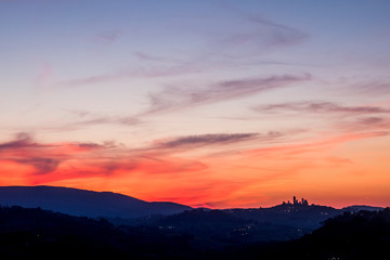Amazing coloured sunset in Tuscany Italy with red clouds and blue ground during the blue hours. Beautiful landscape with colors and feeling
