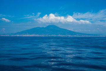 seaview from cruise boat of naples with vesuvio vulcan and campania cliff of italy in mediterranean water. wave and travel concept for tourist in summer vacation enjoying europe