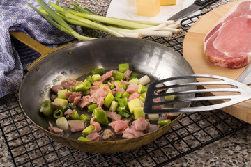 preparing a very irish dish colcannon with spring onion and bacon