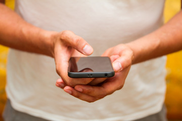 Male hands using smartphone. person holding a tactile mobile smartphone