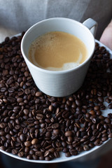 black coffee on a tray in male hands.