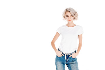 Fototapeta premium Attractive blonde young adult woman with hands in pockets isolated on white