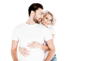 Beautiful smiling couple amorously hugging isolated on white