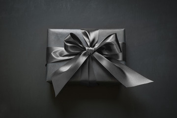 Gift box wrapped in black ribbon. Top view.