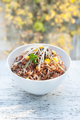 Bowl of wild rice,close-up in garden setting