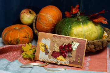 Card with flowers and pumpkins in the basket