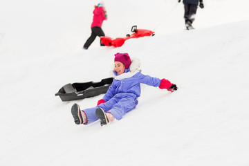 childhood, sledging and season concept - group of happy little kids with sleds on snow hill in winter