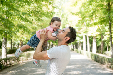 Beautiful baby in the park with her father