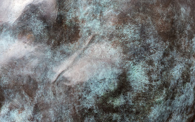 A dark mountainous surface in close-up with daylight
